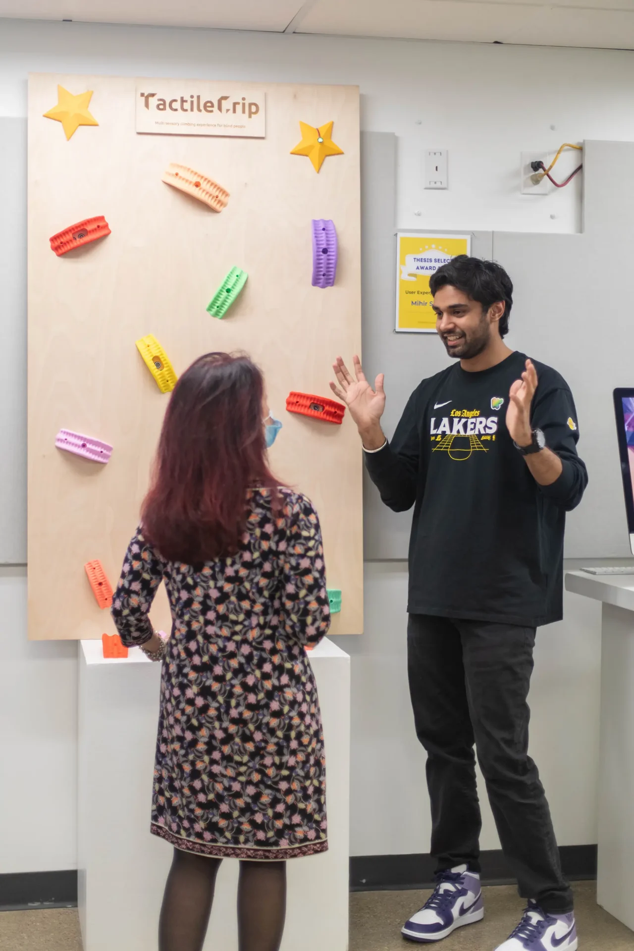 A graduate student is explaining their project to faculty.