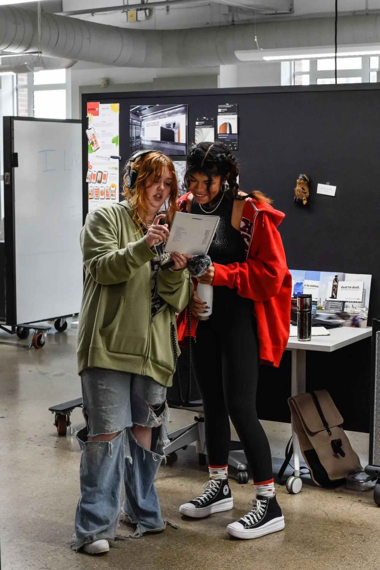 Two students reviewing a page with information on it.