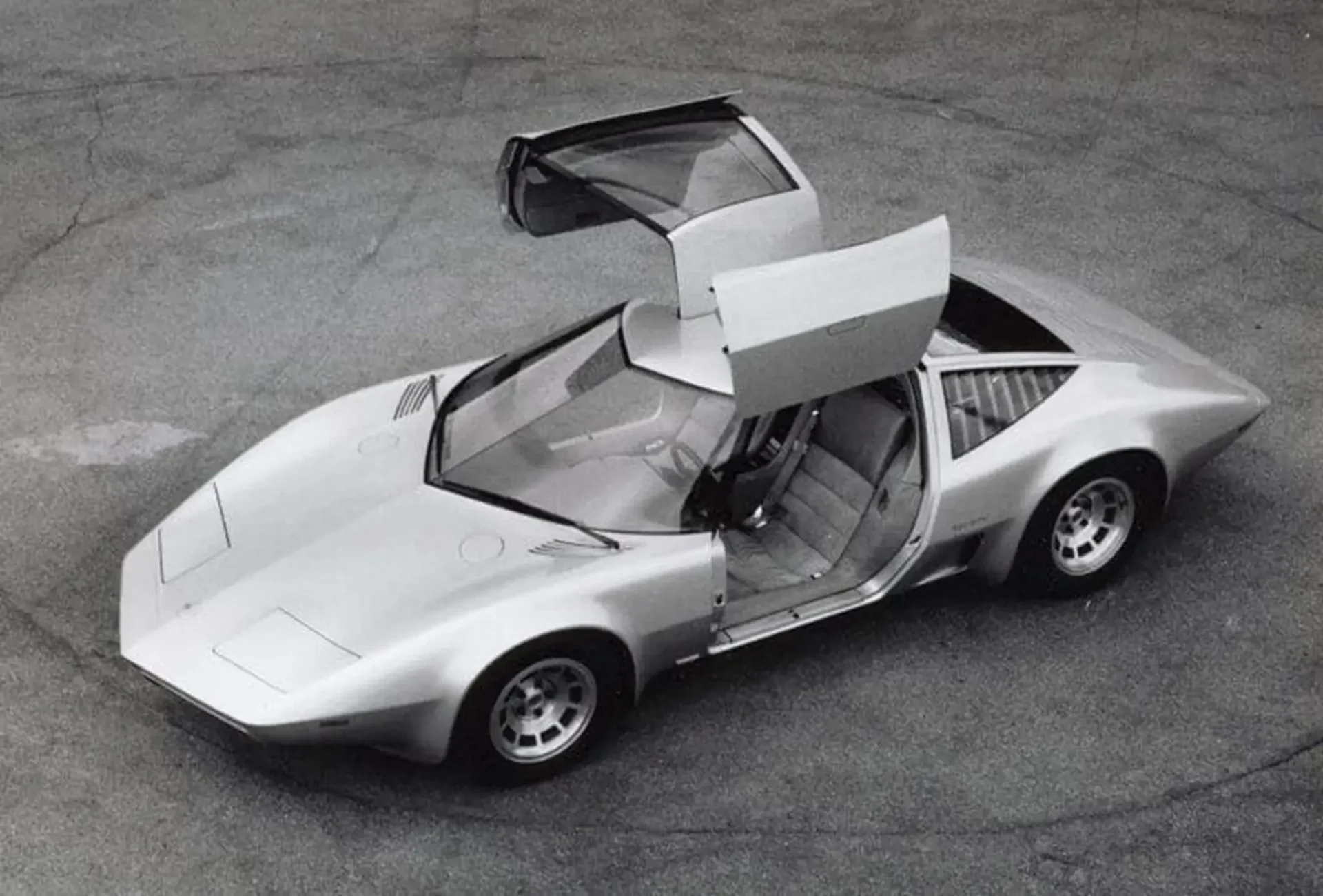 A shot of a sports car with the doors raised up
