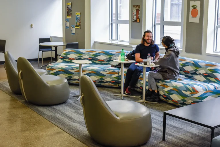 Students talking with each other in a lounge area.