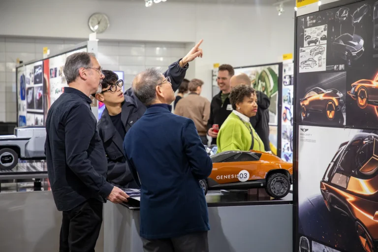 A student showing off his work to industry partners.