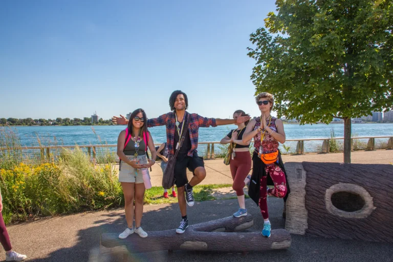 Students happy and peaceful by the Detroit River.