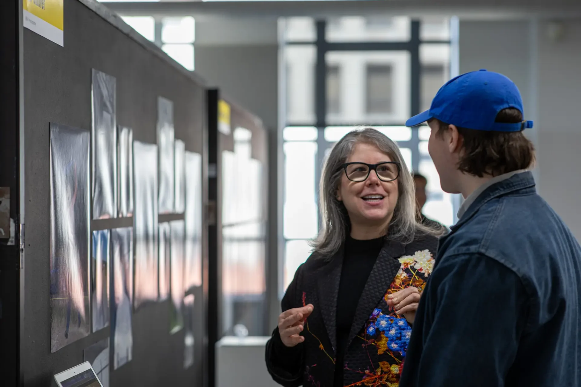 Faculty with a student discussing work.