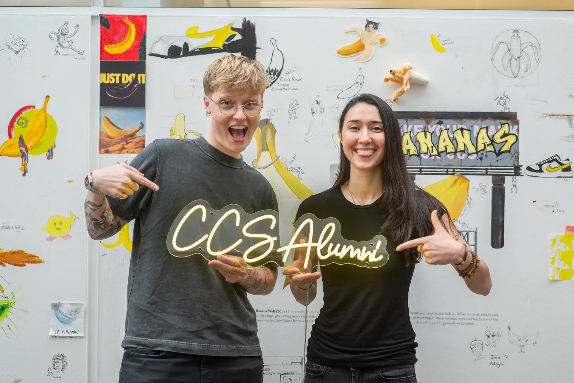 A students holding up a CCS Alumni sign