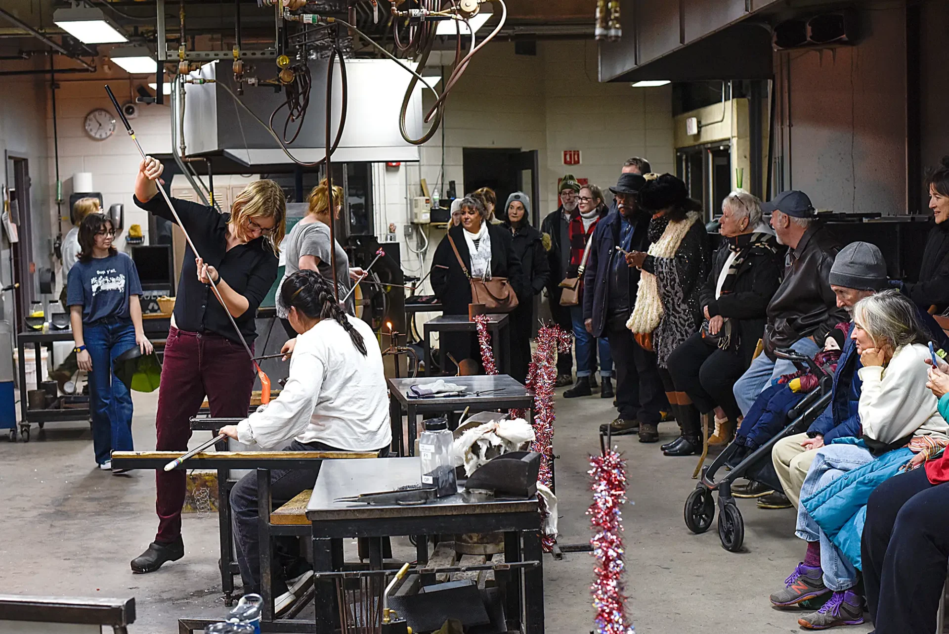 Community joins together in CCS's glassblowing studio to watch students and faculty create glass with winter themes.