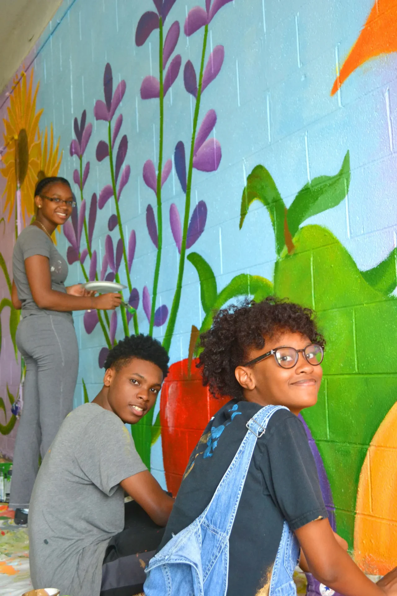 Artists in the community giving back by painting a mural.