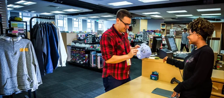 Someone asking an employee about a CCS branded hat at the bookstore