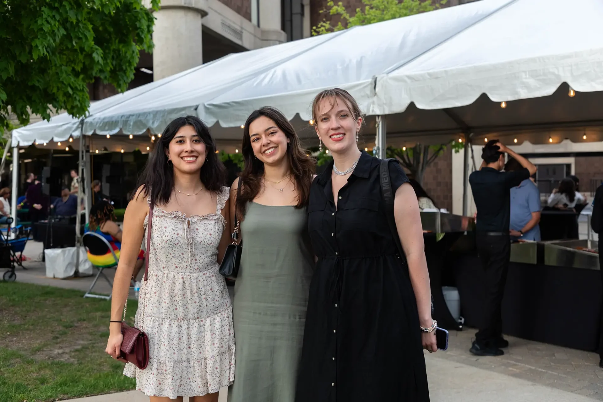 Three alumni in the Sculpture Garden at the 100th CCS Student Exhibition Opening in 2026