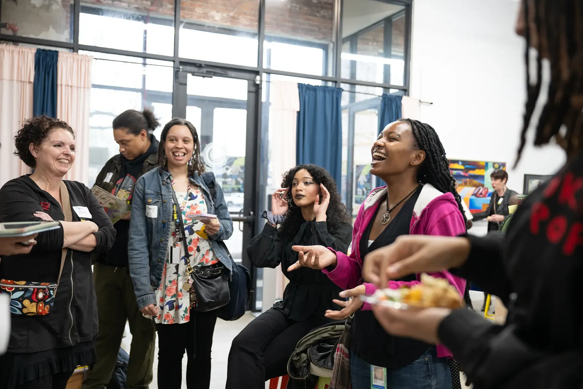 Alumni and students laughing at the Motown Mixer networking event in Detroit