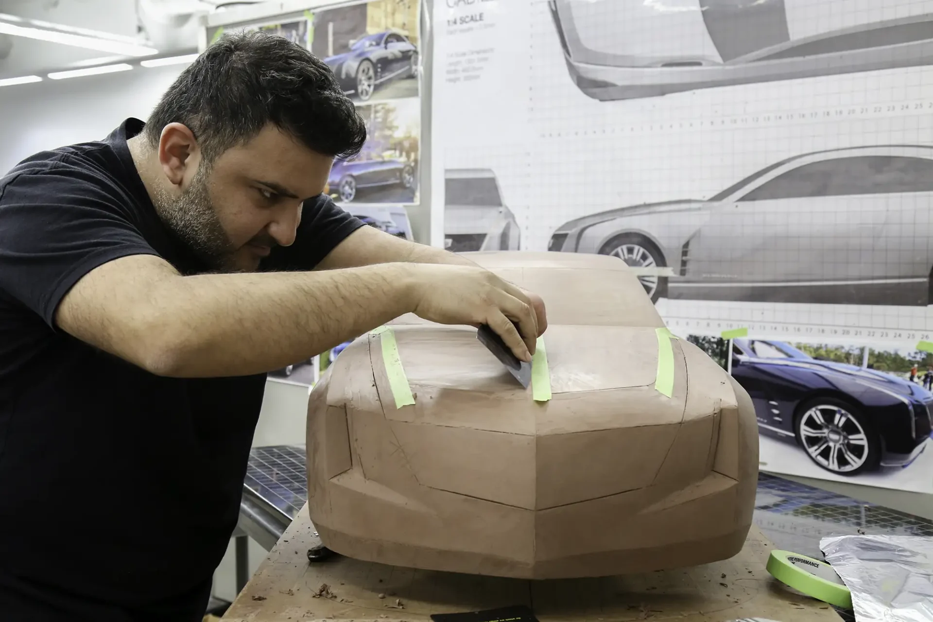 A man sculpting a clay model.