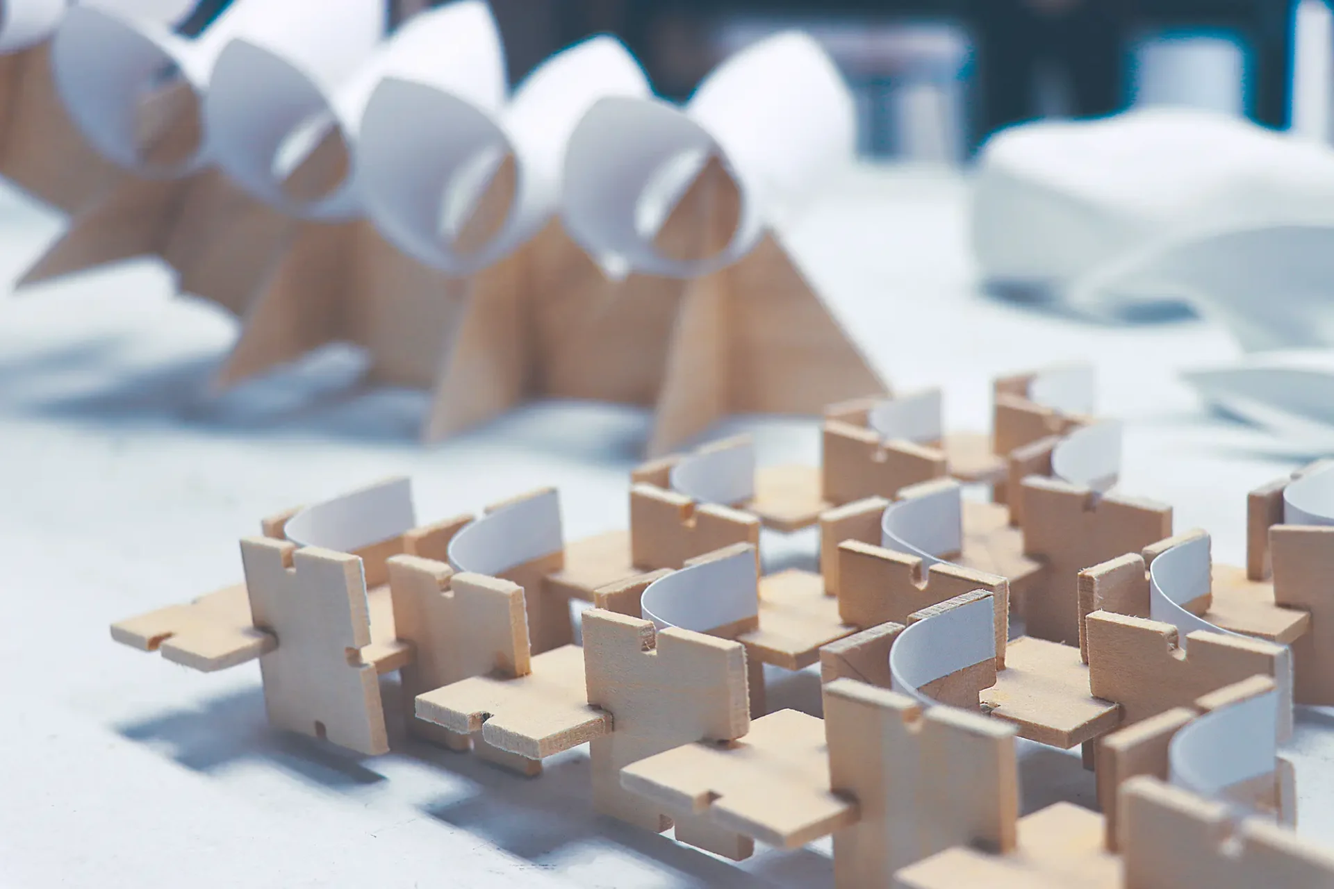 Closeup detail of a 3D wood and paper sculpture.