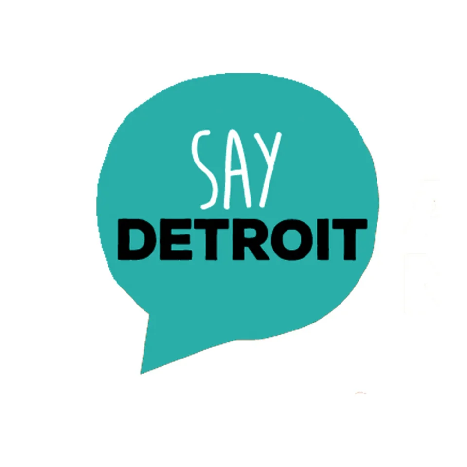 Logo for SAY Detroit featuring a teal speech bubble containing the words "SAY DETROIT."