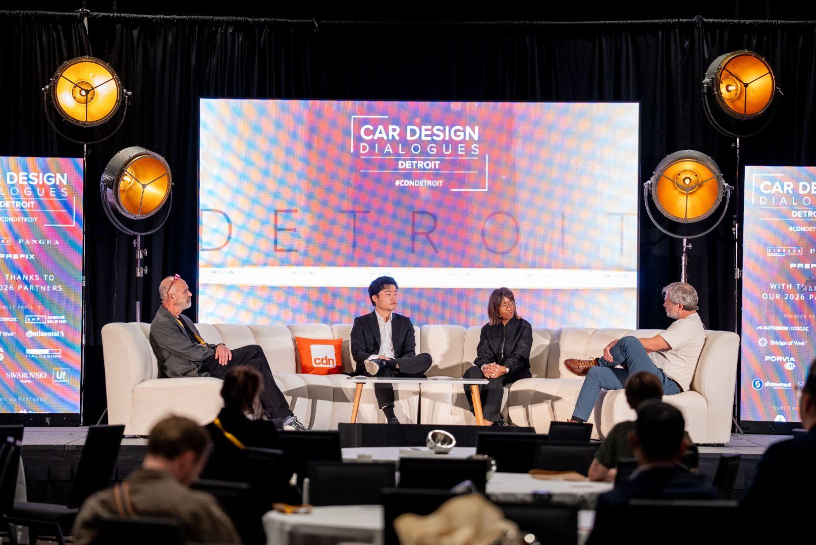 Four panel guests—Paul Snyder, Jason Song, Crystal Windham, and James McLachlan—sit on a stage couch during Car Design Dialogues Detroit event.