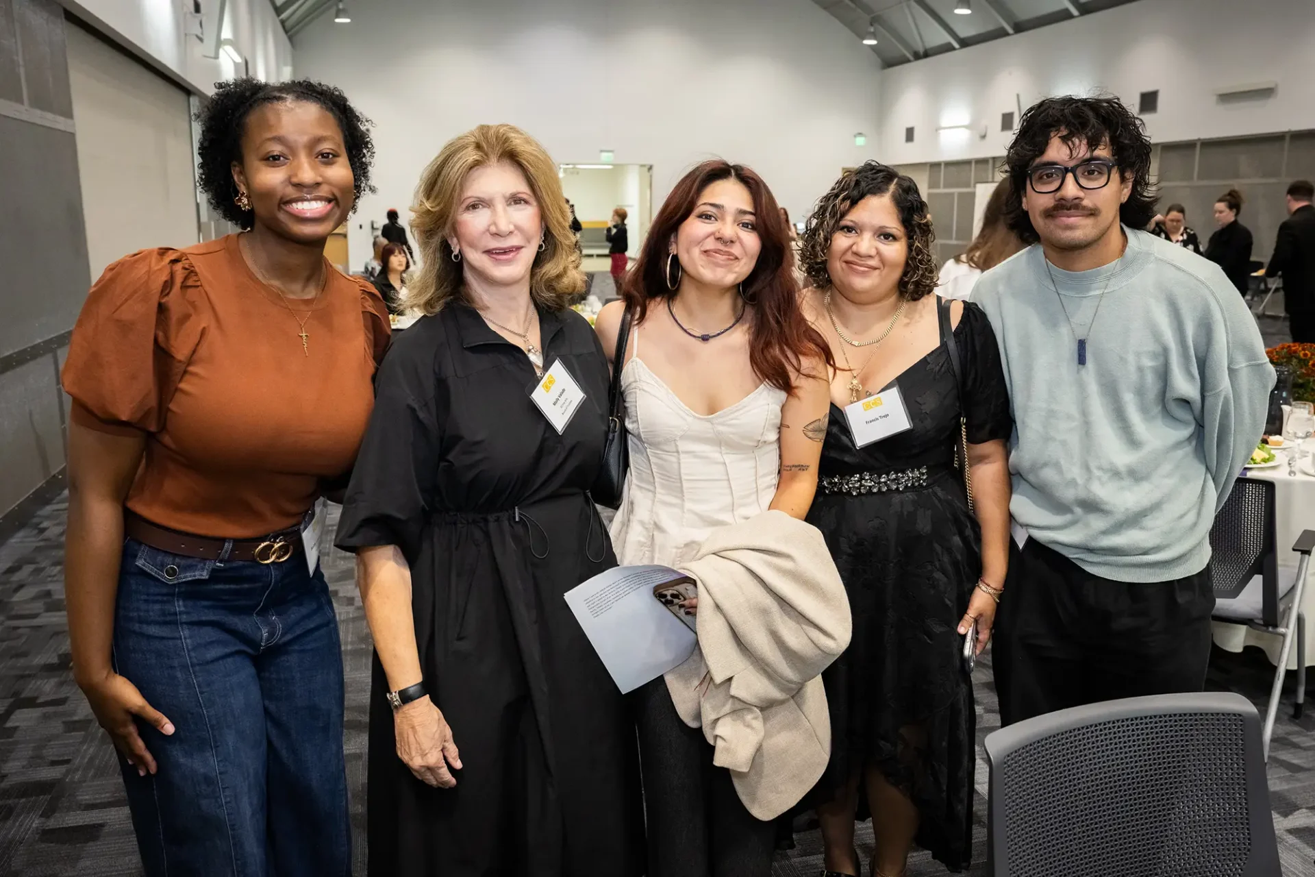 A group of five smiling people posing together indoors at the CCS Donor Appreciation Celebration.